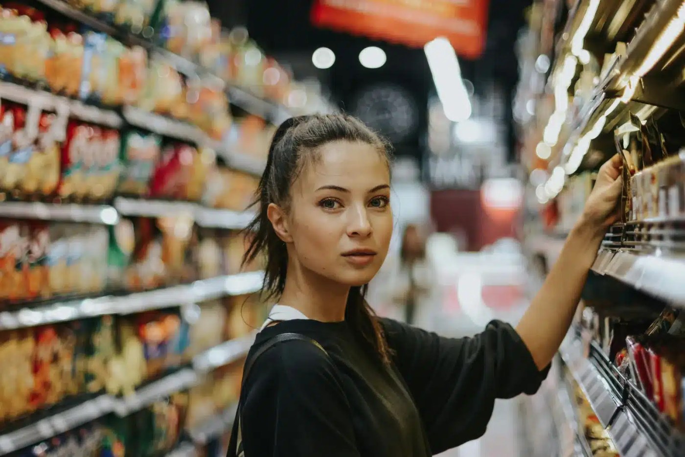 Young person in a grocery store aisle, a key sector for youth employment in Canada